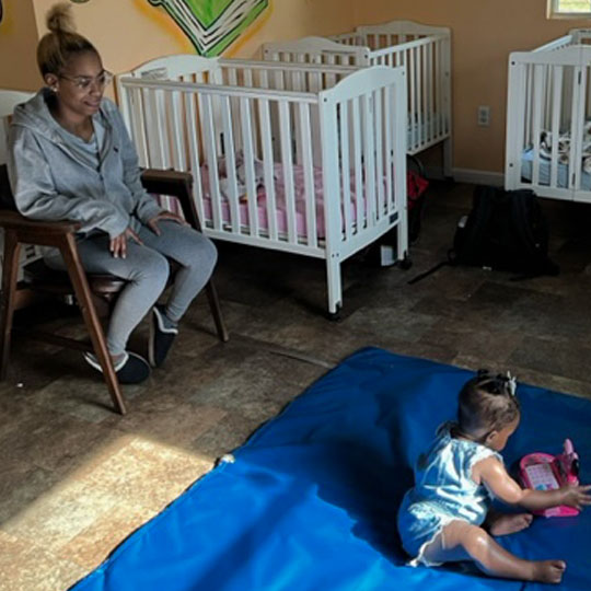 Small children playing on playmat.